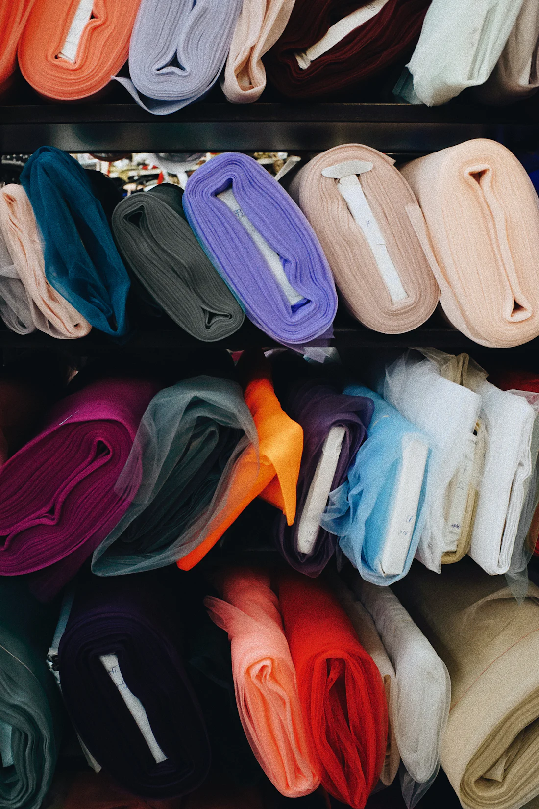 Shelves of fabric rolls in many colours