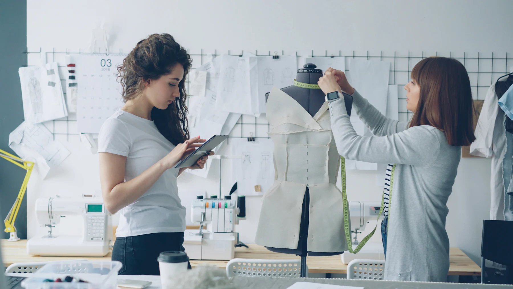 Fashion designer checking a garment on a dress form in a design studio