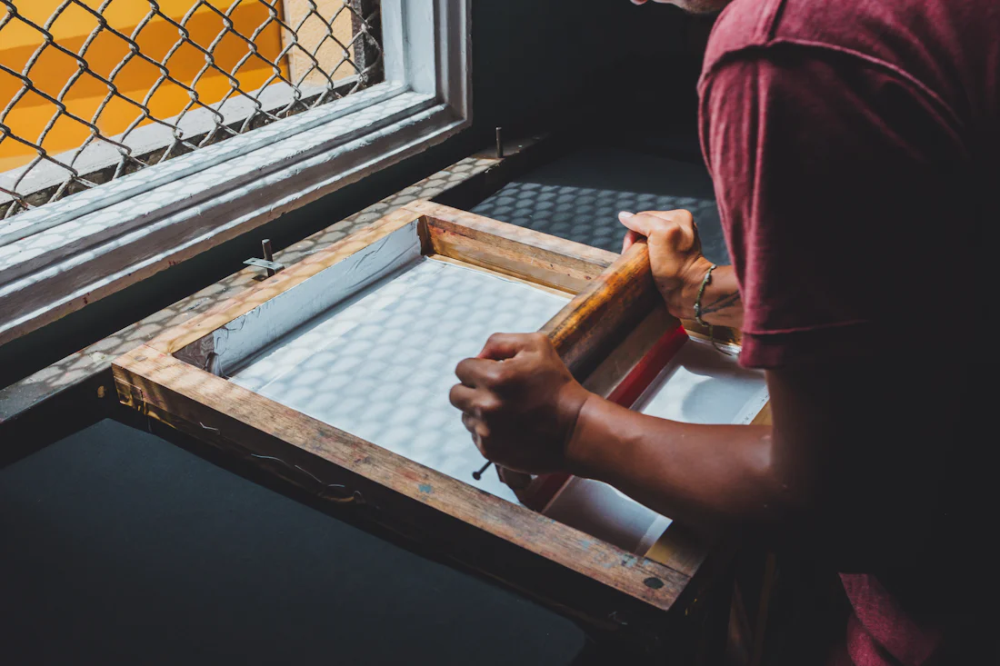 Printer pulling a screen print by hand