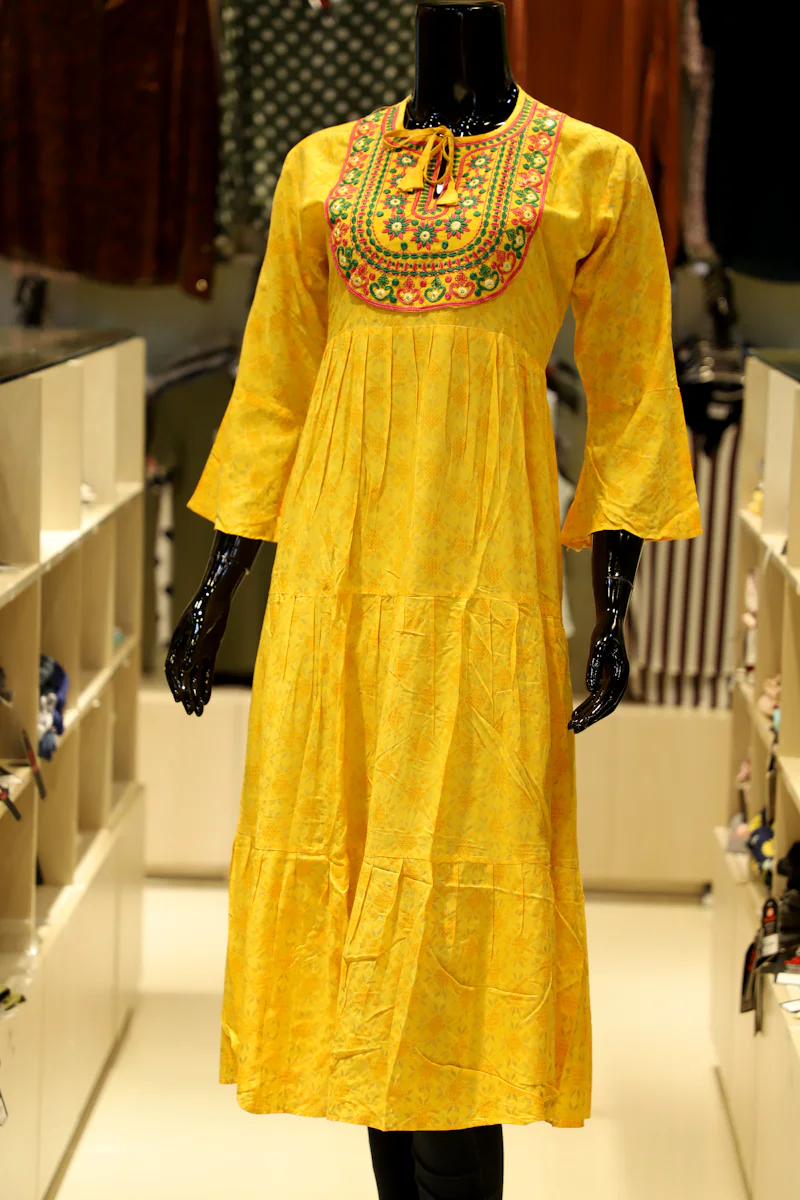 Yellow tiered dress on a mannequin